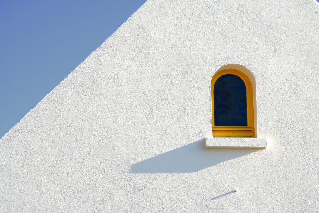minimalist image of a window casting an angled shadow