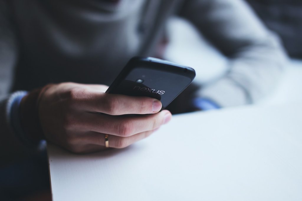 close up of a hand holding a smartphone
