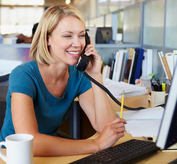 Woman talking on business phone in office setting